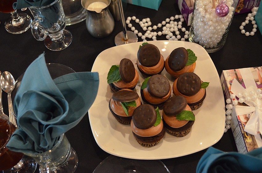 Vanilla cupcakes with chocolate frosting and a Girl Scout Thin Mint cookie with mint garnish were served for dessert.