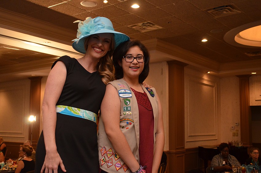 Junior League model Lindsay Gartrell — who is also a Girl Scout Brownie troop leader — poses on the runway with Girl Scout Emily Amado. Gartrell wore a Chaus dress that was originally around $90, but was found at Goodwill for $6.99.