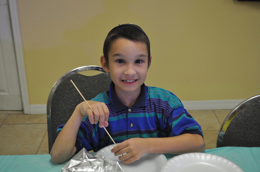 Shaya Bukiet, 8, skewers watermelon and grapes.