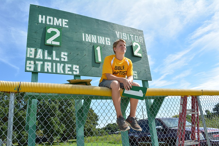 Noah Bean, 15, changes the scoreboard.