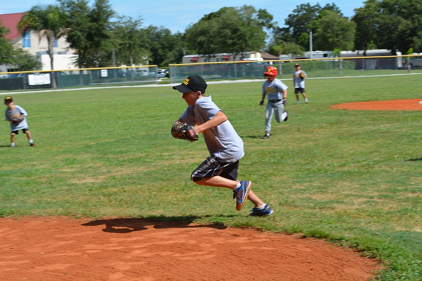 Nolan Enger, 12, races to beat a runner to third base for an out.
