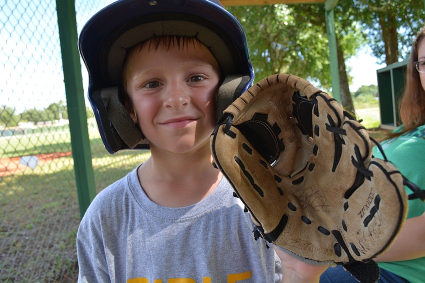 Aiden Enger, 7, likes hitting and fielding the ball, he says.