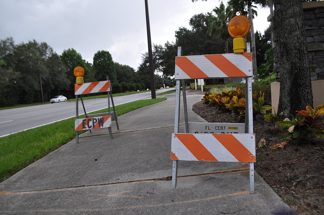 Barricades denote places where sections of the sidewalk have lifted along Lakewood Ranch Boulevard.