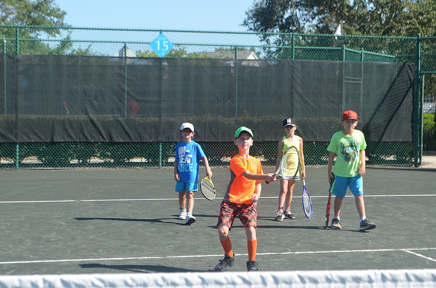 Cort Griffin, 7, hits the ball while other campers wait their turn.