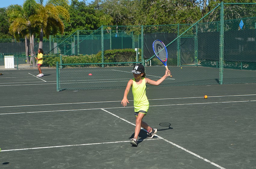 Nina Tahar, 9, on vacation form France, gets ready for the ball to cross to her side of the court.