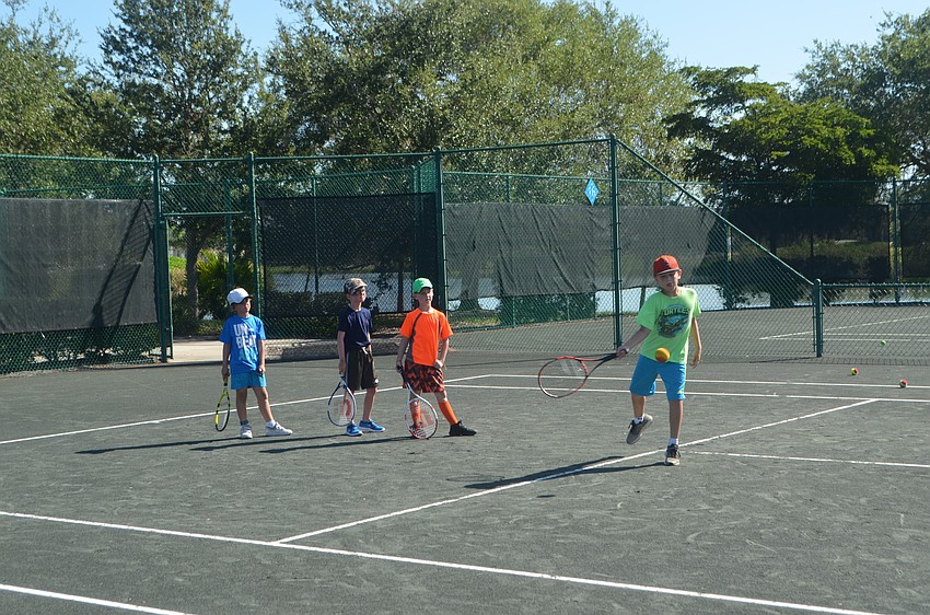 Jackson McLeod, rallies with camp director Briana Francois while other campers wait their turn.