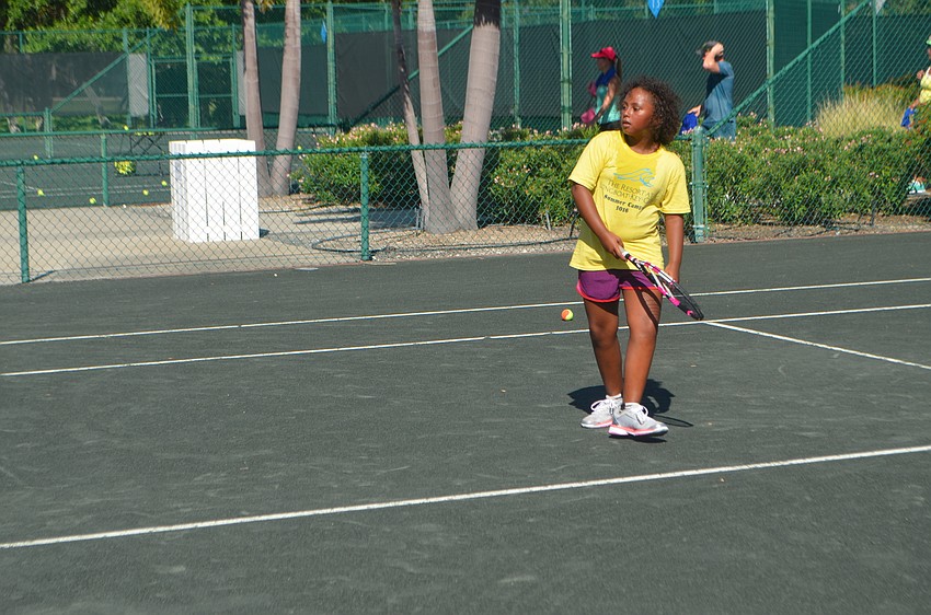 Shama Green, 9, gets ready for the ball to cross over to her side of the court.