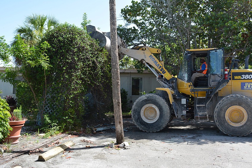 A front-end loader started demolition of one small portion of the former Colony Beach & Tennis Resort.