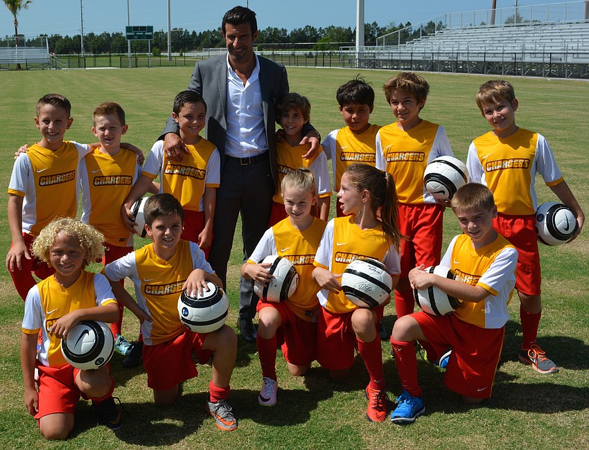 Portuguese soccer legend Luis Figo posed with several players from the Chargers Soccer Club at Premier Sports Campus.