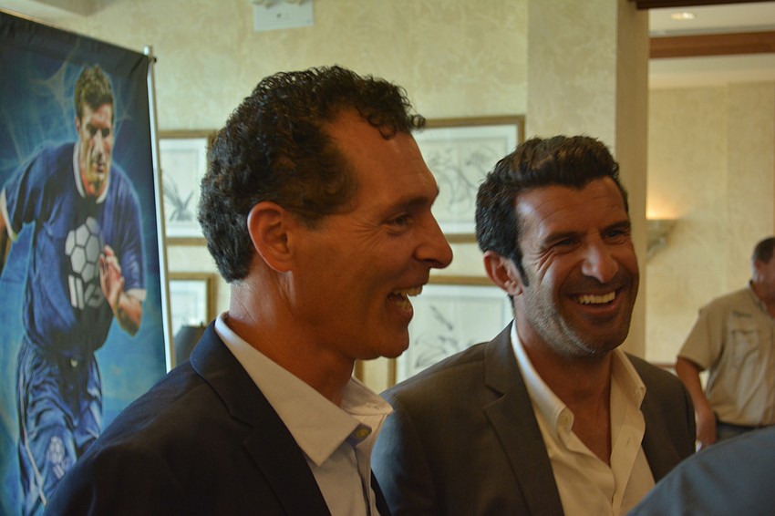 Antonio Saviano, the director at Premier Sports Campus, shares a laugh with Luis Figo during Thursday's press conference.