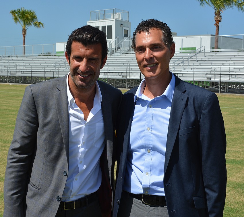 Luis Figo and Antonio Saviano check out Premier's showcase field.