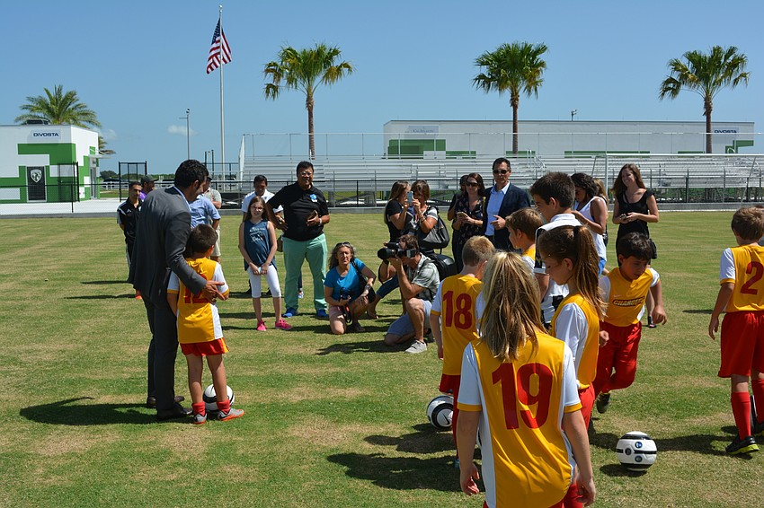 Members of the Chargers Soccer Club waited in line for photos with Luis Figo at Premier Sports Campus on Thursday.