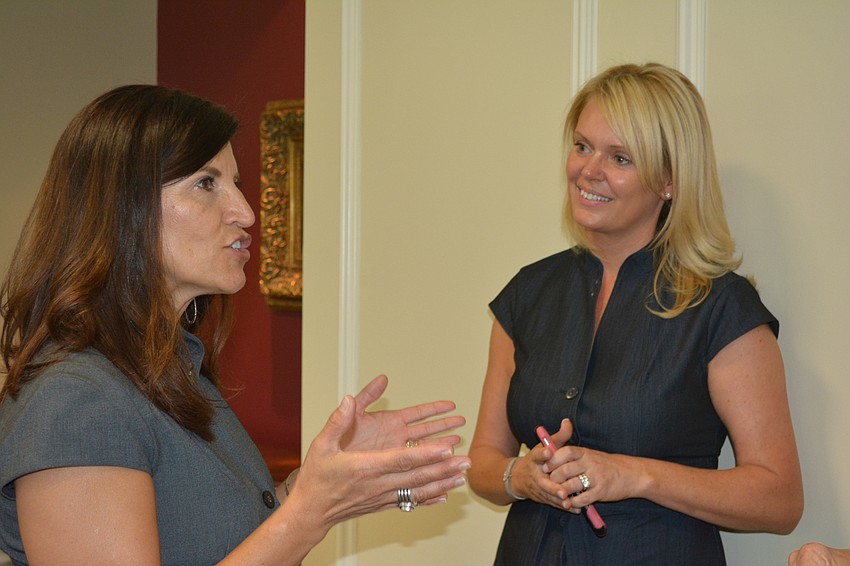 Sisterhood for Good member Violeta Huesman visits with Kelly Fox, who accepted a grant on behalf of the Mark Wandall Foundation.