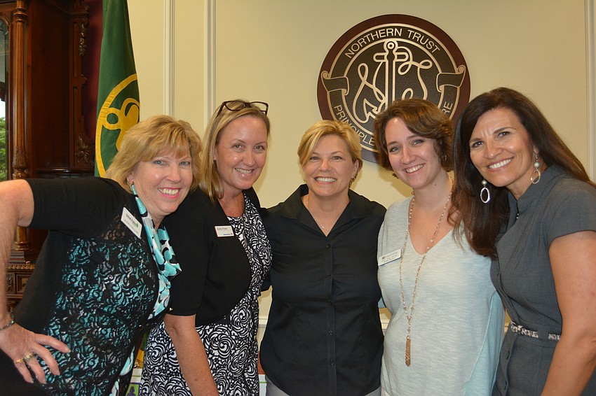 Sisterhood for Good members Kathy Collums, Kathy Fraley, Angela Massaro-Fain, Shelby Isaacson and Violeta Huesman celebrate after handing out five grants on Thursday.