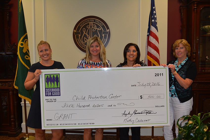 Michelle McSwain accepts a check on behalf of Child Protection Center along with Sisterhood for Good members Heather Kasten, Lori Ruth and Kathy Collums.