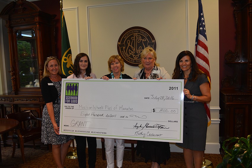 Kathy Fraley (Sisterhood), Lauren Aristizabal (Meals on Wheels Plus), Kathy Collums (Sisterhood), Maribeth Phillips (Meals on Wheels Plus) and Violeta Huesman (Sisterhood) carry the big check.