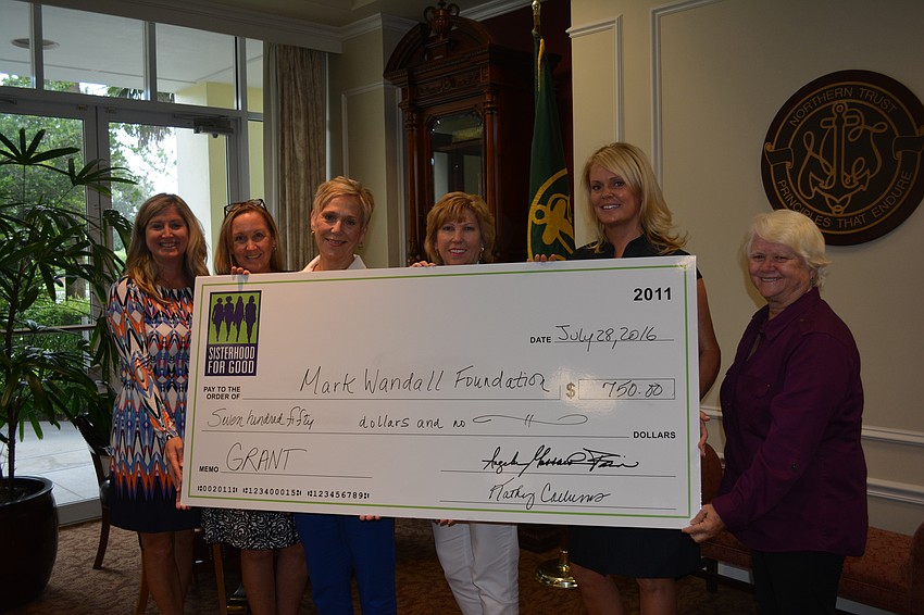 Heather Kasten, Kathy Fraley, Kathy Westhoff, Kathy Collums, Kelly Fox and Mary Nastan handle the big check presented to the Mark Wandall Foundation.
