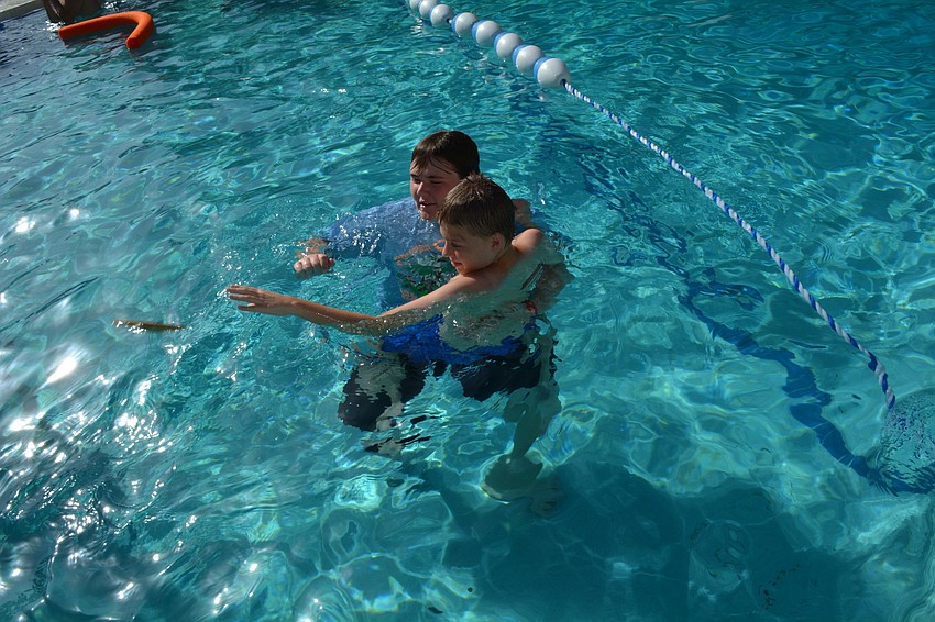 Mark Eastman, 12, hangs out with counselor Luke Vrunner, a student at Braden River High.