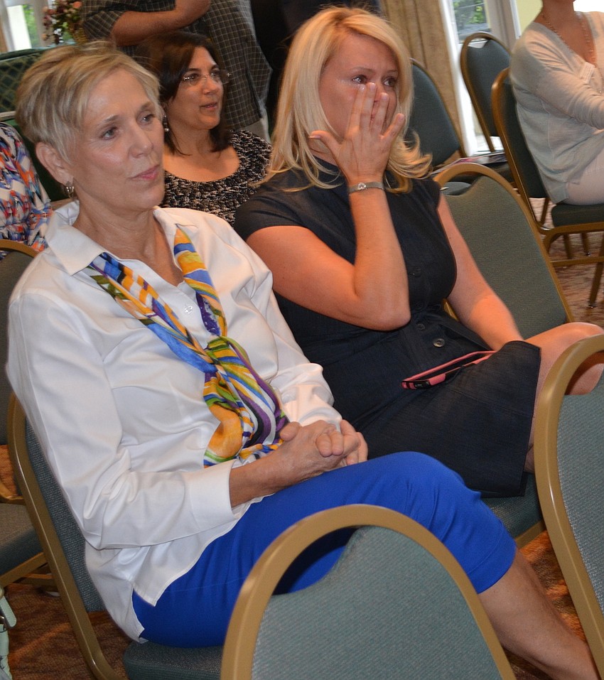 Kelly Fox, right, is emotional after receiving a grant on behalf of the Mark Wandall Foundation from the Sisterhood for Good. With her is foundation representative Kathy Westhoff.