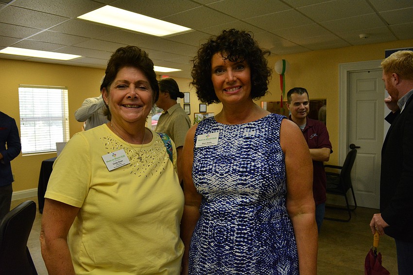 Food Bank Director Cindy Sloan and Meals on Wheels PLUS vice president of Marketing and Community Relations Sheri Aiello greet guests.