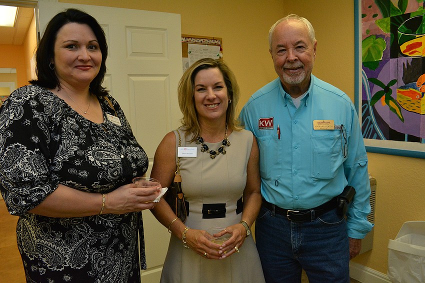 Annemarie Graff and Cherri Kessler, of BMO Harris Bank, pose with Richard Curtis, of Keller Williams.
