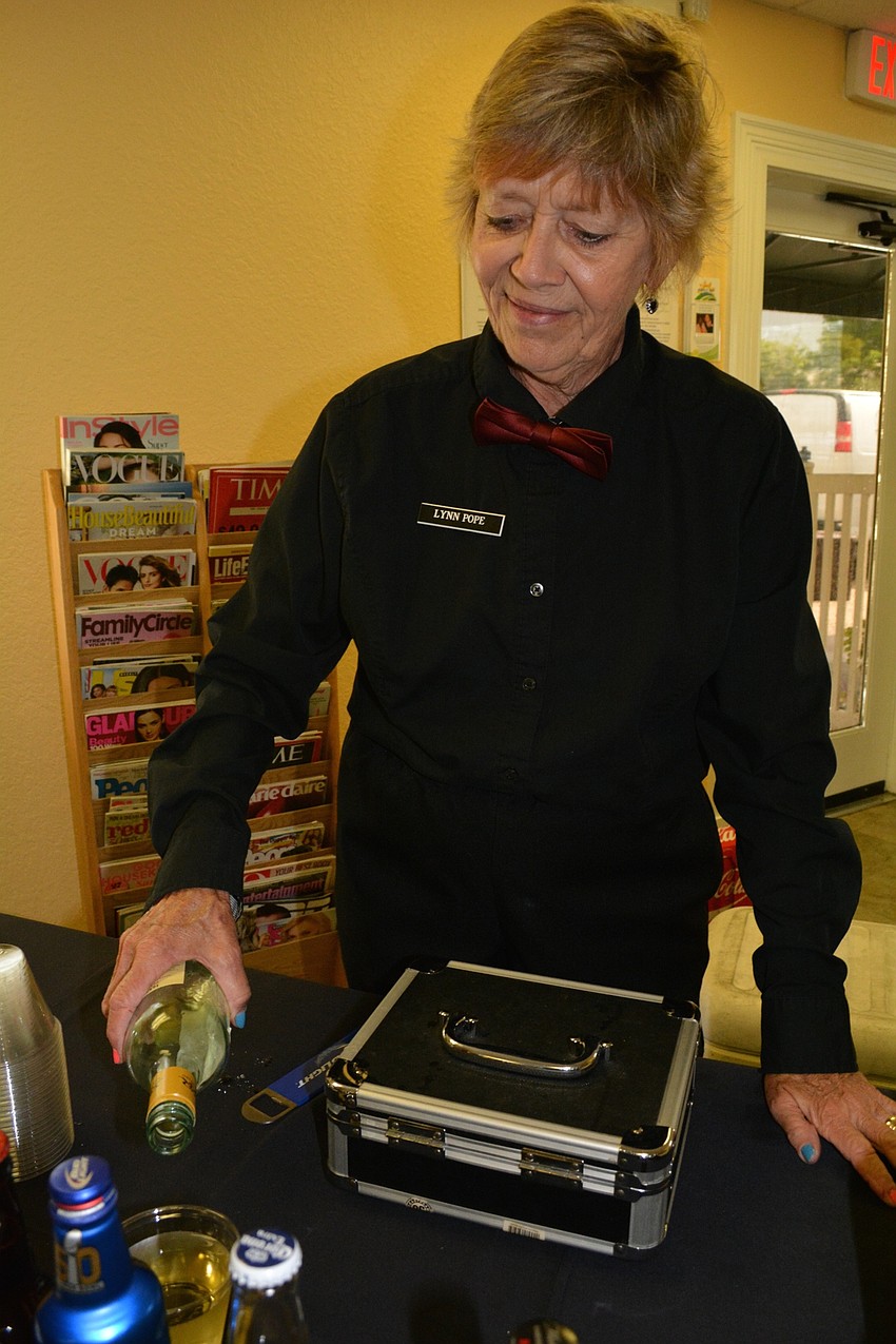 East County resident Lynn Pope serves drinks to guests on behalf of Renaissance on Ninth.