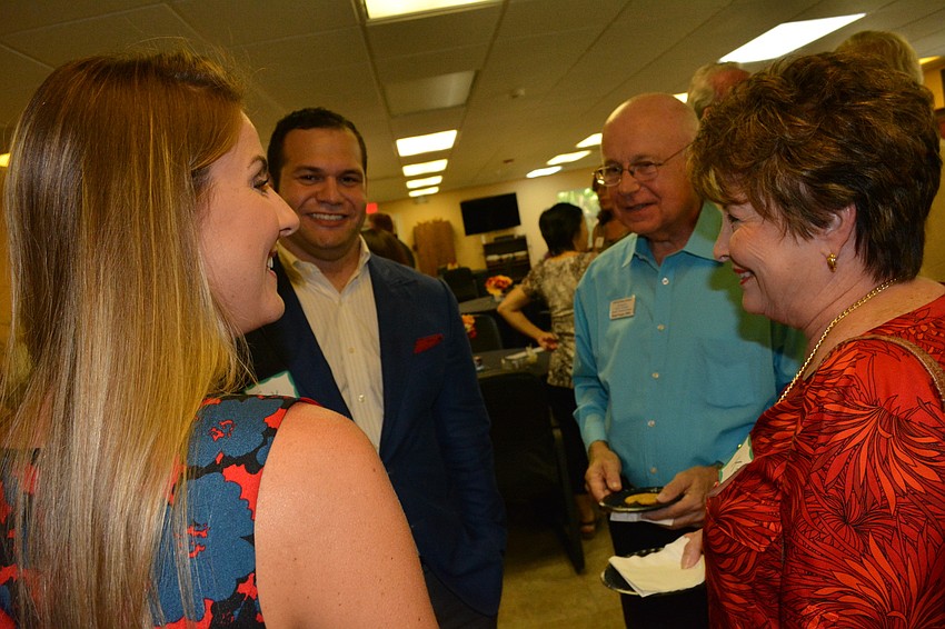 Clockwise from front left: Stephanie Grepling, of Meals on Wheels PLUS, chats with Erik Arroyo, of Band, Gates and Dramis Attorneys and Hank and Kay Progar, of AIM Safe Money Advisors.