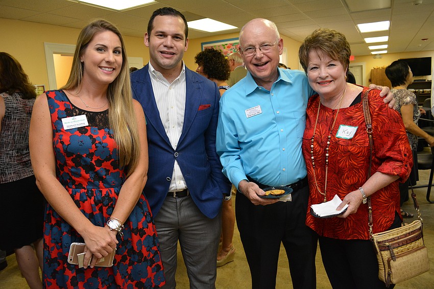 Stephanie Grepling, of Meals on Wheels PLUS, chats with Erik Arroyo, of Band, Gates and Dramis Attorneys and Hank and Kay Progar, of AIM Safe Money Advisors.