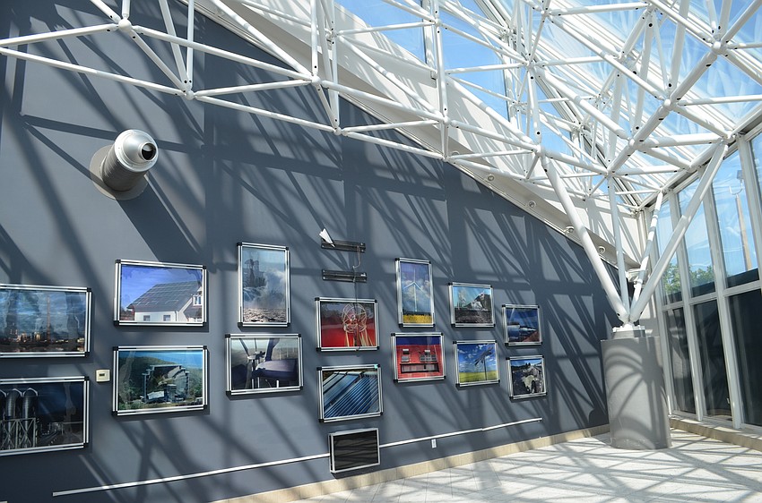 Photos hang on the walls in the building's glass atrium.