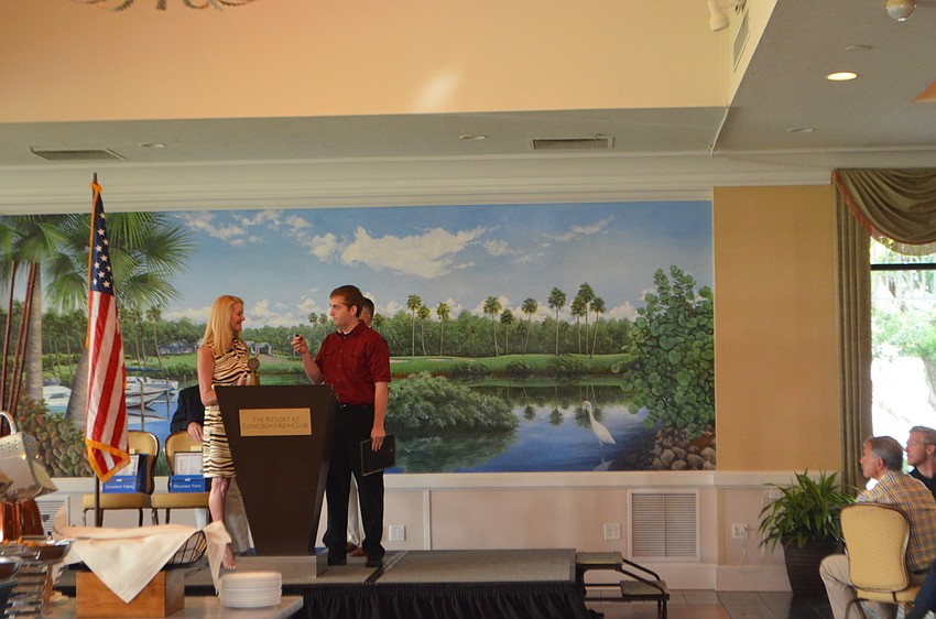 Charlie Anthofer accepts his academic scholarship.