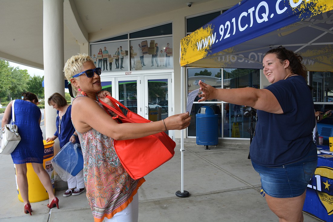 Rosenda Calloway drops off $30 worth of groceries from Publix and receives a $5 off coupon to Goodwill stores from Morghan Sanders, of 92.1 CTQ.