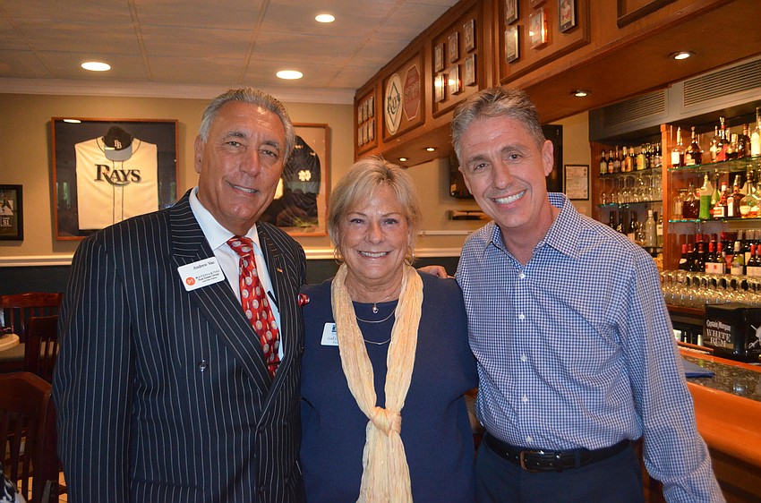 Andrew Vac of Matusiak/Vac Real Estate, Chamber President Gail Loefgren, at owner of The Lazy Lobster Michael Garey