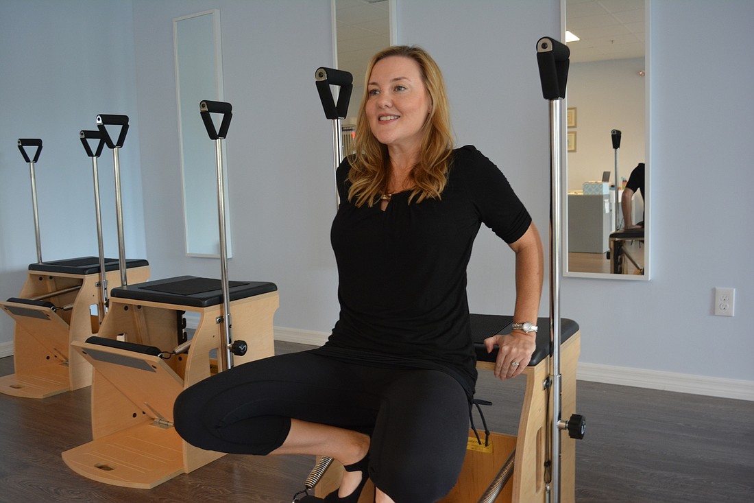 Allison Gregory, owner of the new Lakewood Ranch Pilates studio, demonstrates some moves on the Wunda Chair.