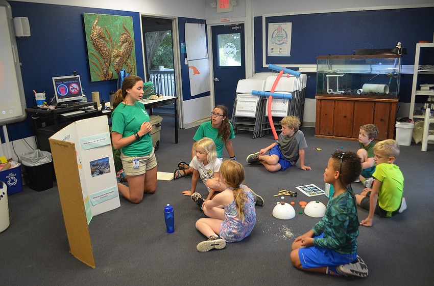 Mote employee Michelle Marinangel explains how coral get their food to the Aqua Kids.