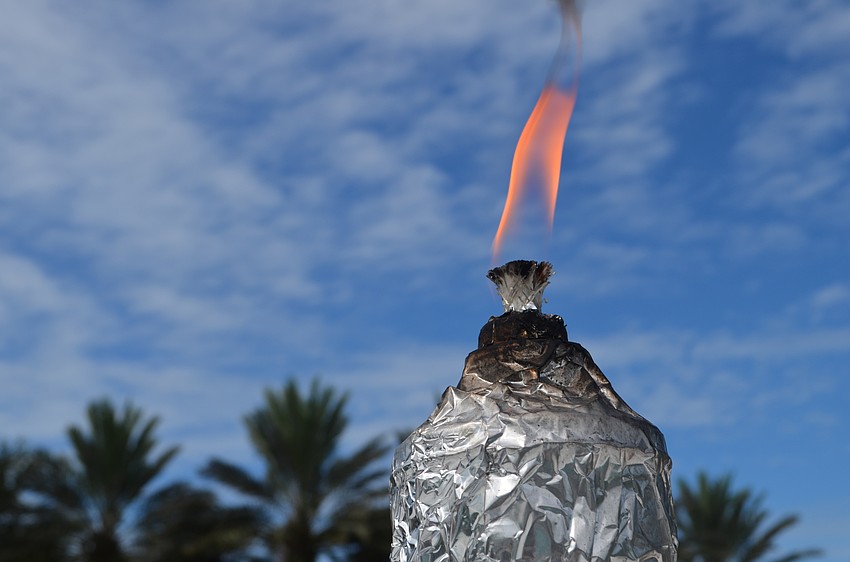 The torch is lit each morning by the pool at the fitness center.