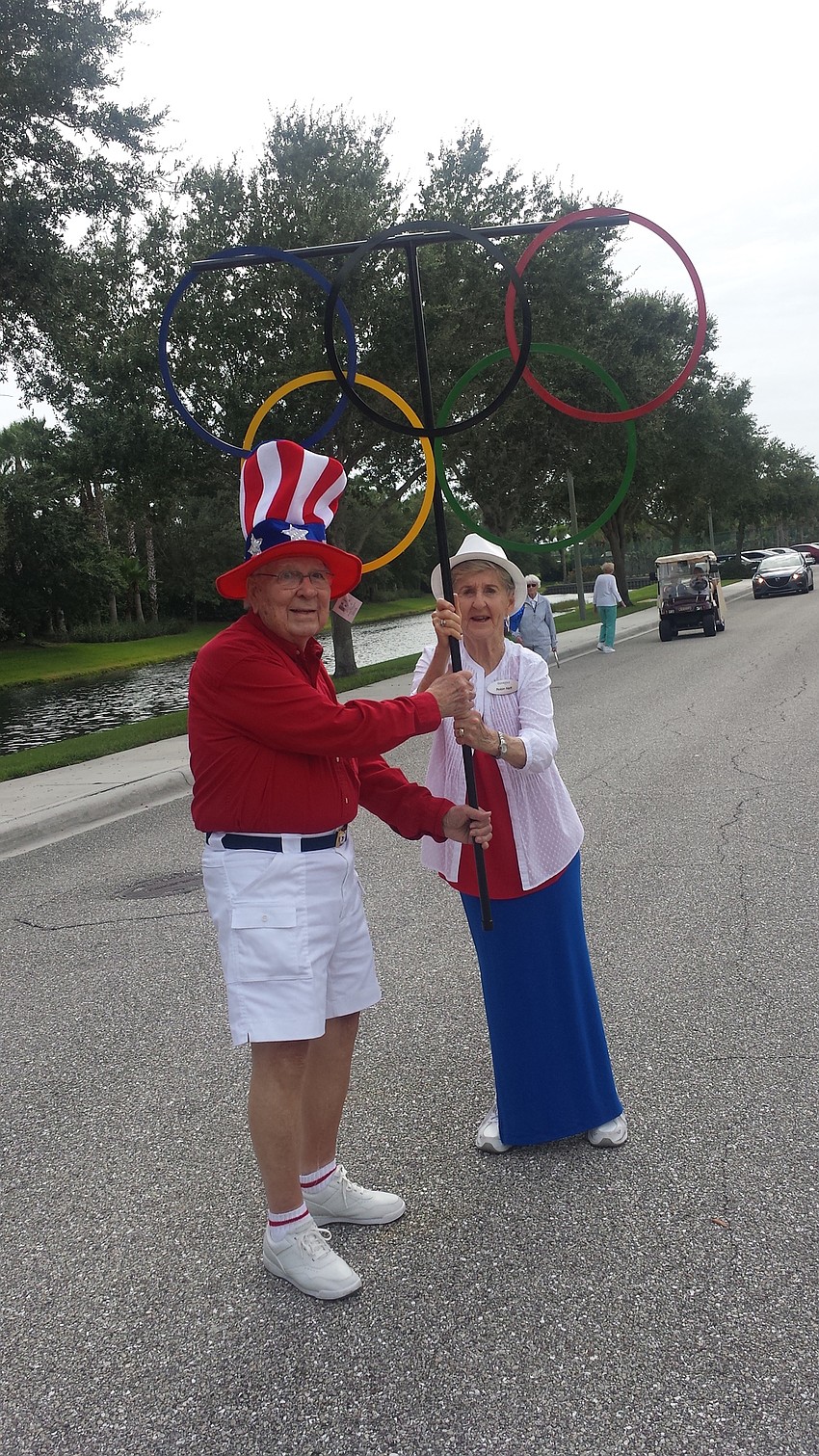 Courtesy photo. The Glenridge members Dale Grove and Robin Neff participate in the Olympic torch walk/run Friday, Aug. 12 to open the Senior Olympics.
