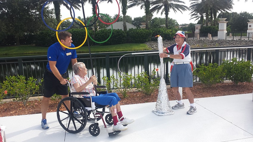Courtesy photo. Dr. Edward Feldman lights the torch to signal the start of The Glenridge Senior Olympics.