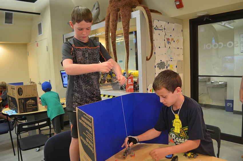 Xander Oleksak, 9, and Sebastian Brochu, 10, move their Lego pieces before taking pictures for their stop motion video.