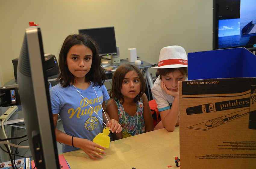 Callahan Hernandez, 10, her sister Lucia, 8, and Leonardo Susini, 10 watch their stop motion video.