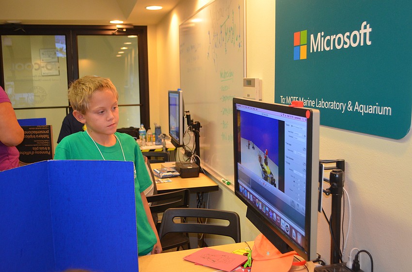 Amaury Bernard, 9, watches the stop motion video before taking more pictures.