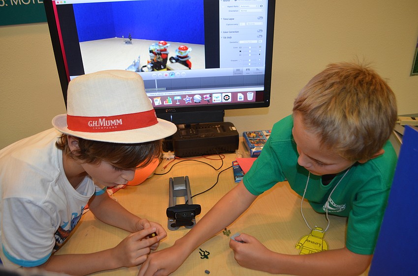 Leonardo Susini, 10, and Amaury Bernard, 9, rearrange their Lego pieces.