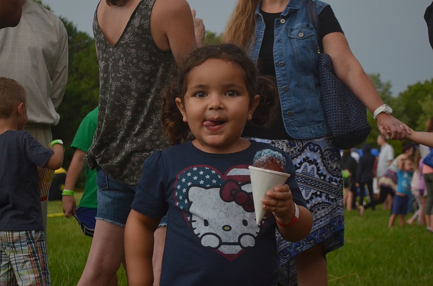 Giana DeJesus, 3, enjoys a snow cone at Woodland Community Christian's Back to School Bash.
