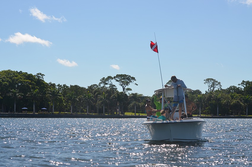 Rene Janneman pulls his group’s rope out of the water before searching other areas of the bay.
