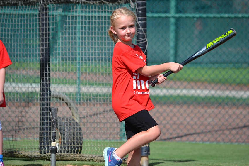 Amelia stretches out her swing at home plate.