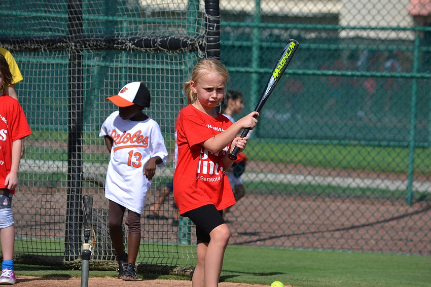 Amelia stretches out her swing at home plate.