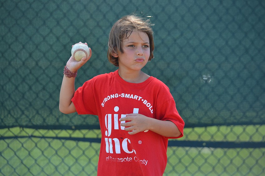 Girls Inc. member Ivy winds up to pitch the ball.