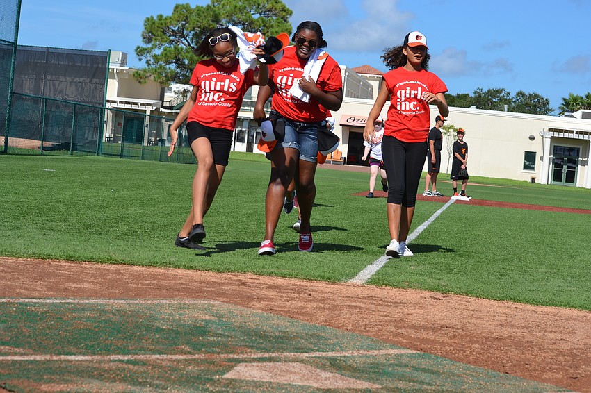 Shaniya, Jabrielle and Desiree run dash to home plate.