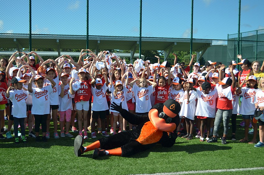 Girls Inc. members pose with the Oriole Bird before the start of the clinic.