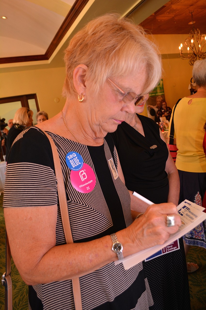JoAnn Matray, of Sarasota, registers to vote with the Democratic Club of Sarasota County.