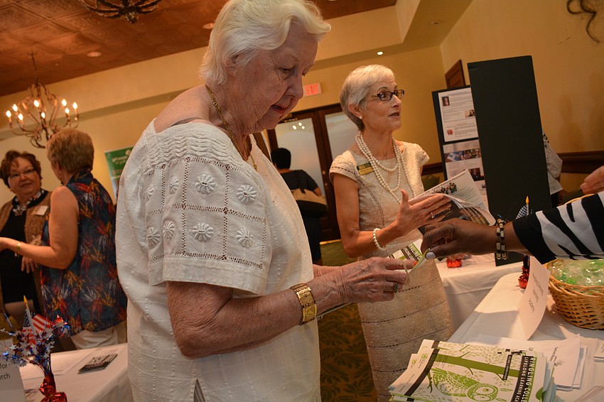 Mary Muller, front, picks up information from the Ringling Lifelong Learning Academy.